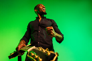 Image showing Young african-american jazz musician playing the guitar