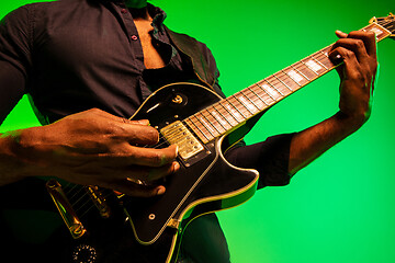 Image showing Young african-american jazz musician playing the guitar