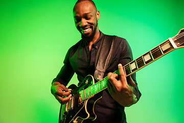 Image showing Young african-american jazz musician playing the guitar