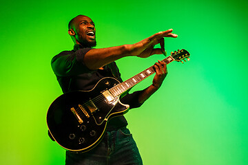 Image showing Young african-american jazz musician playing the guitar