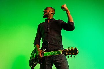 Image showing Young african-american jazz musician playing the guitar