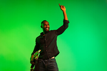 Image showing Young african-american jazz musician playing the guitar