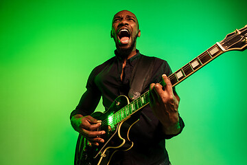 Image showing Young african-american jazz musician playing the guitar