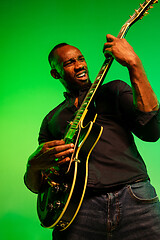 Image showing Young african-american jazz musician playing the guitar