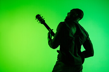 Image showing Young african-american jazz musician playing the guitar