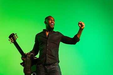 Image showing Young african-american jazz musician playing the guitar