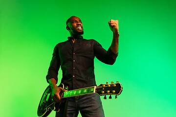 Image showing Young african-american jazz musician playing the guitar