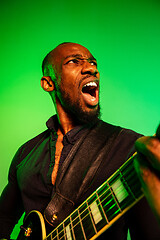 Image showing Young african-american jazz musician playing the guitar