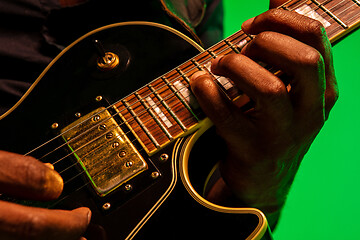 Image showing Young african-american jazz musician playing the guitar