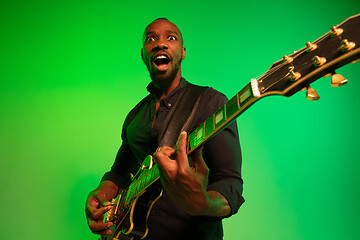 Image showing Young african-american jazz musician playing the guitar