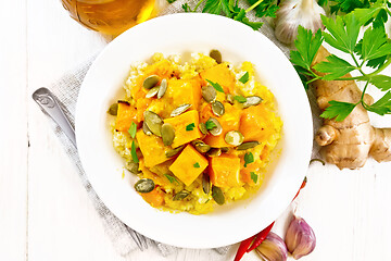 Image showing Porridge millet with spicy pumpkin in plate on board top