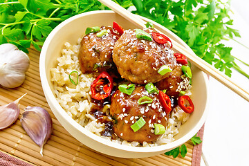 Image showing Meatballs in sweet and sour sauce with rice on bamboo