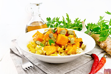 Image showing Porridge millet with spicy pumpkin in plate on white board