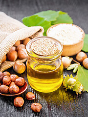 Image showing Oil hazelnut in jar on board