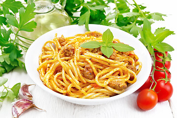 Image showing Spaghetti with bolognese in plate on light wooden board