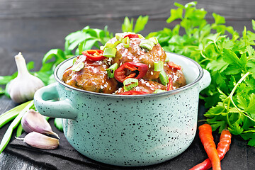 Image showing Meatballs in sweet and sour sauce on dark board