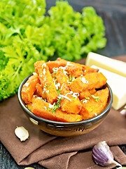 Image showing Pumpkin fried with spices in bowl on napkin