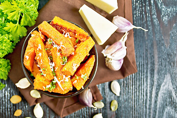 Image showing Pumpkin fried with spices in bowl on dark board top