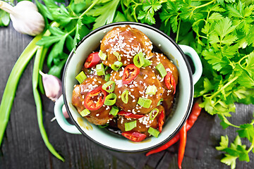 Image showing Meatballs in sweet and sour sauce on board top