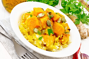 Image showing Porridge millet with spicy pumpkin in plate on light board