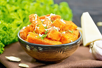 Image showing Pumpkin fried with spices in bowl on board