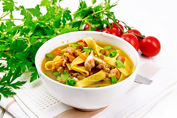 Image showing Soup with mung and noodles in bowl on wooden board