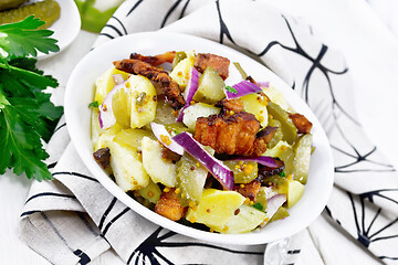 Image showing Salad potato with bacon and cucumber in plate on napkin