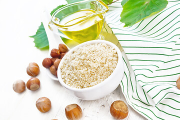 Image showing Flour hazelnut in bowl on wooden board