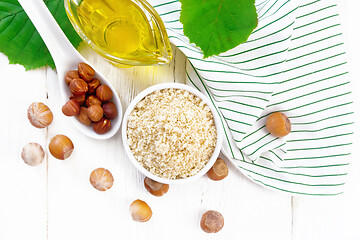 Image showing Flour hazelnut in bowl on board top