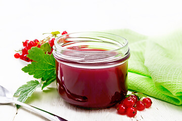 Image showing Jam of red currant in jar on light board