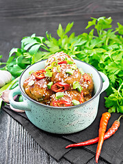 Image showing Meatballs in sweet and sour sauce on wooden board