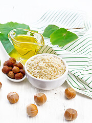 Image showing Flour hazelnut in bowl on light wooden board