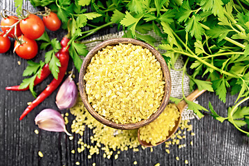 Image showing Bulgur in bowl with vegetables on dark board top