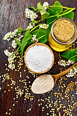 Image showing Flour buckwheat green in bowl with flowers on board