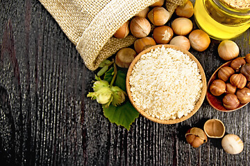 Image showing Flour in bowl with nuts on board top