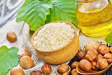 Image showing Flour in bowl with oil on wooden board