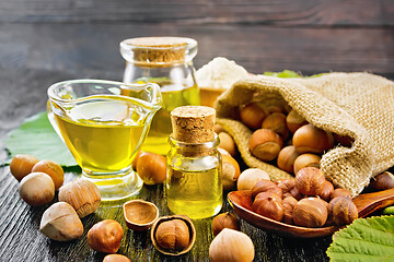 Image showing Oil hazelnut in vial on wooden board