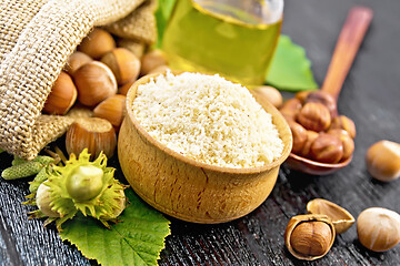 Image showing Flour in bowl with nuts on board