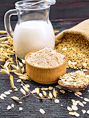 Image showing Flour oat in bowl with oatmeal on board