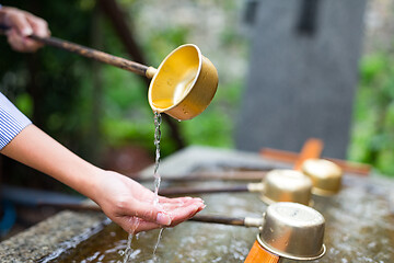 Image showing Woman washing hand in water fountain