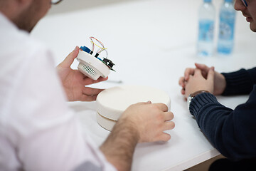 Image showing engineers working and discussing about project