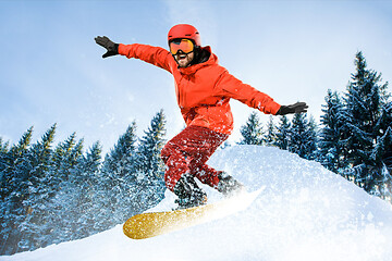 Image showing Young man and winter sport, skiing against white alps mountains