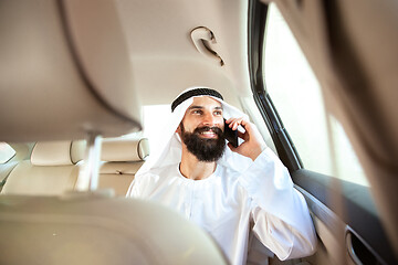 Image showing Arabian saudi businessman working in his car