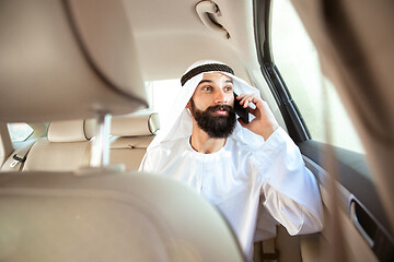 Image showing Arabian saudi businessman working in his car