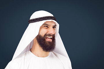 Image showing Arabian saudi businessman on dark blue studio background