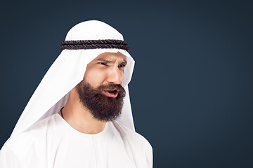 Image showing Arabian saudi businessman on dark blue studio background