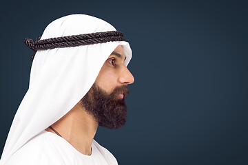 Image showing Arabian saudi businessman on dark blue studio background