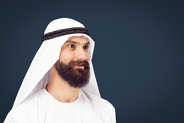 Image showing Arabian saudi businessman on dark blue studio background