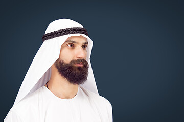 Image showing Arabian saudi businessman on dark blue studio background