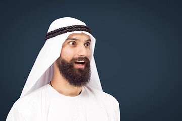 Image showing Arabian saudi businessman on dark blue studio background